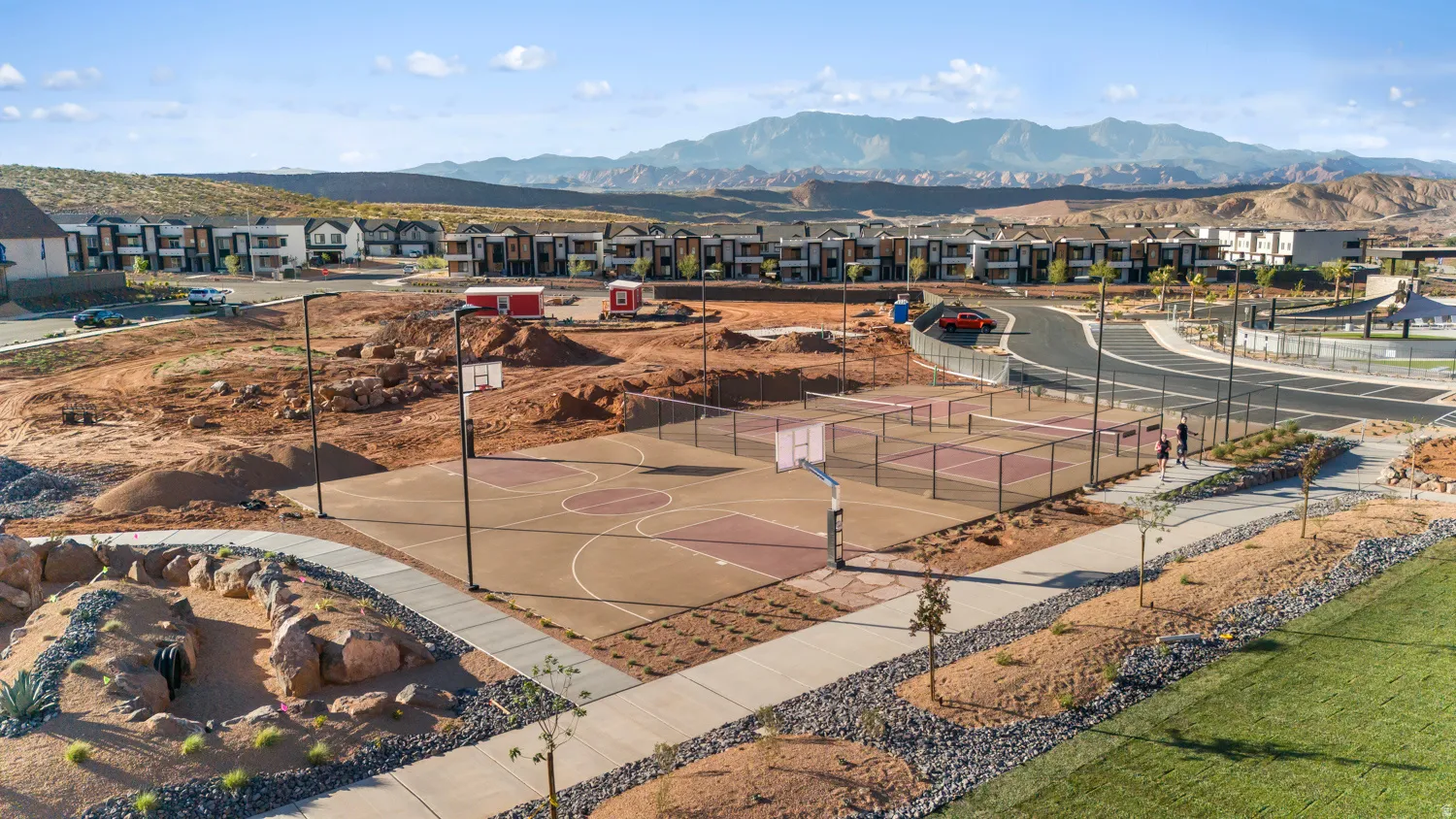 Multi-sport court featuring basketball hoops and tennis nets