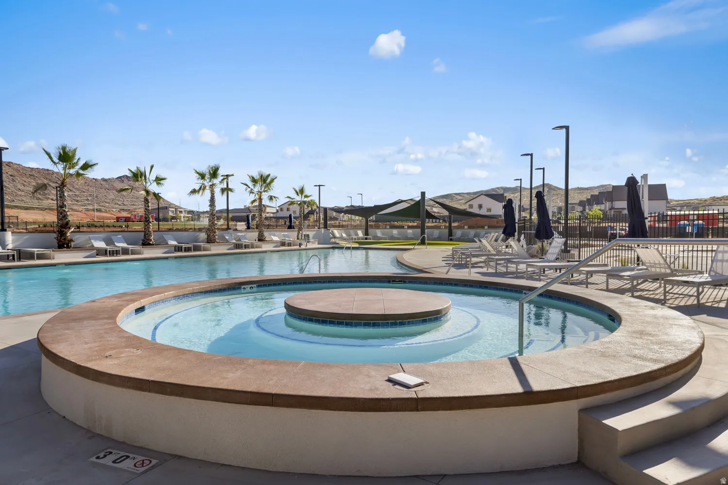 Circular spa with an integrated water feature and tiled interior