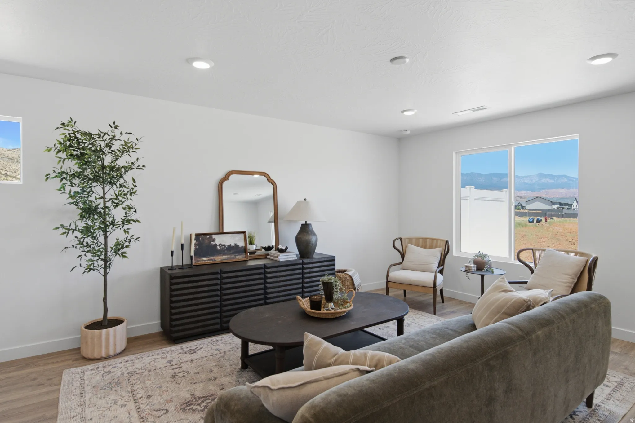 Bright living space featuring recessed ceiling lighting and light wood-finish flooring