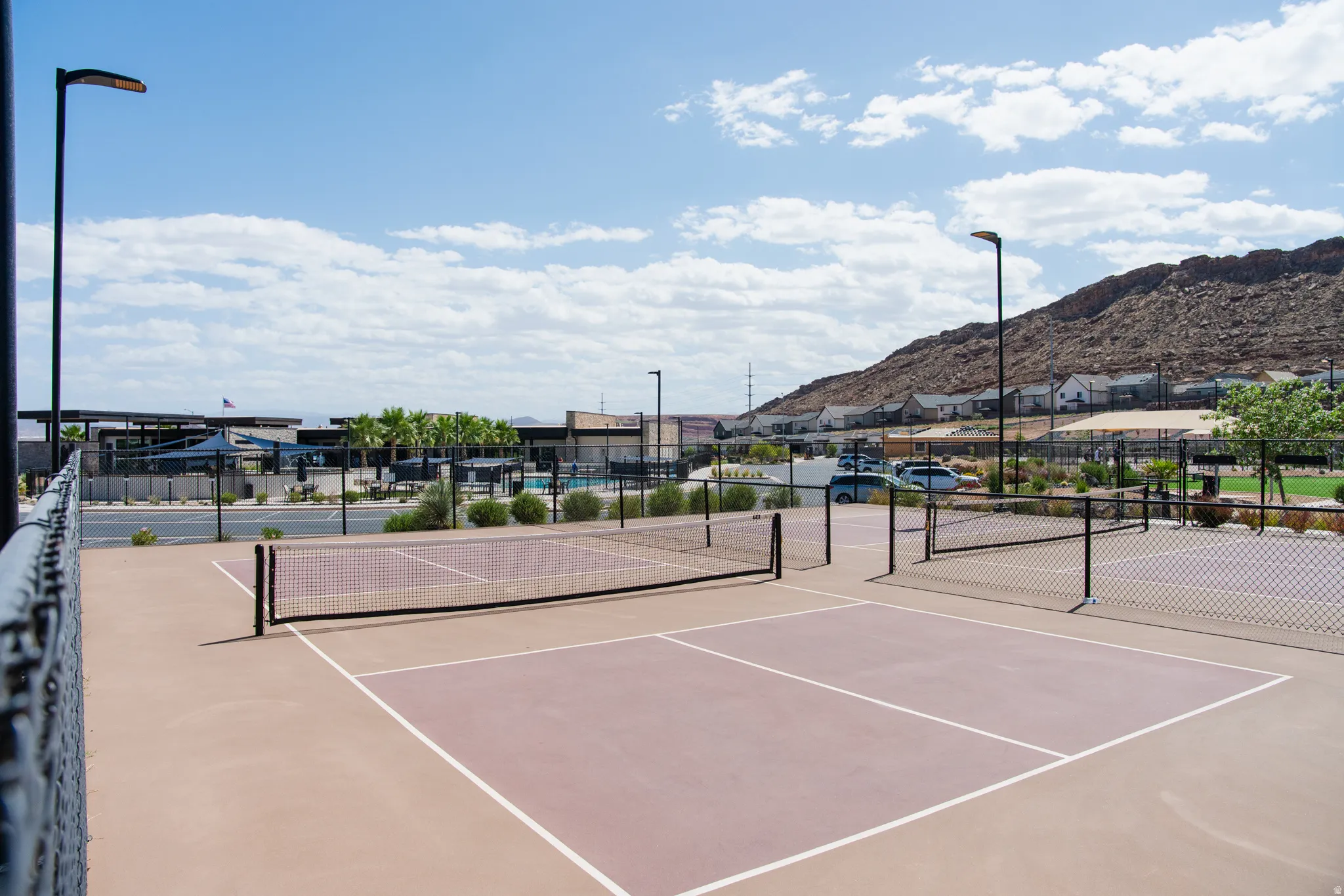 Professional recreational sports court featuring multiple playing surfaces with regulation line markings, durable court flooring, and integrated lighting infrastructure