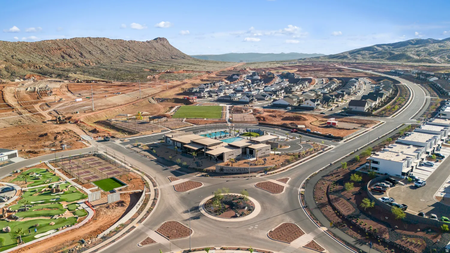 Aerial view showcasing a planned community with mountain backdrops