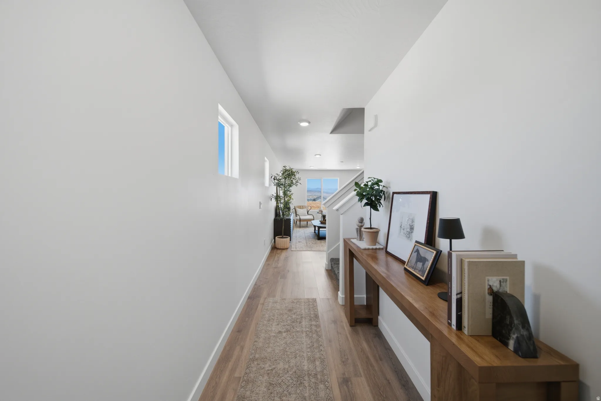 Entryway featuring wood-finish flooring, white walls, and recessed lighting