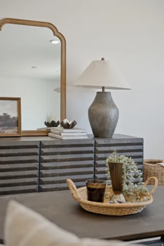 Dark wood-finish credenza with a textured facade, featuring a light wood-framed mirror