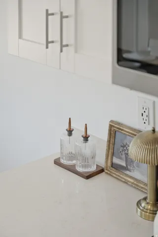 Light-toned countertop with subtle veining, paired with white shaker-style cabinetry featuring brushed nickel hardware