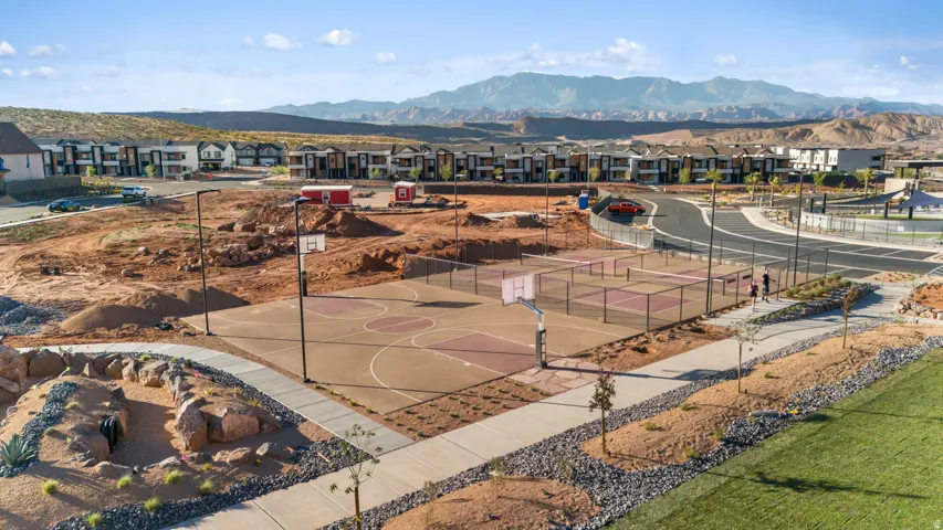 Multi-sport court featuring basketball hoops and tennis nets