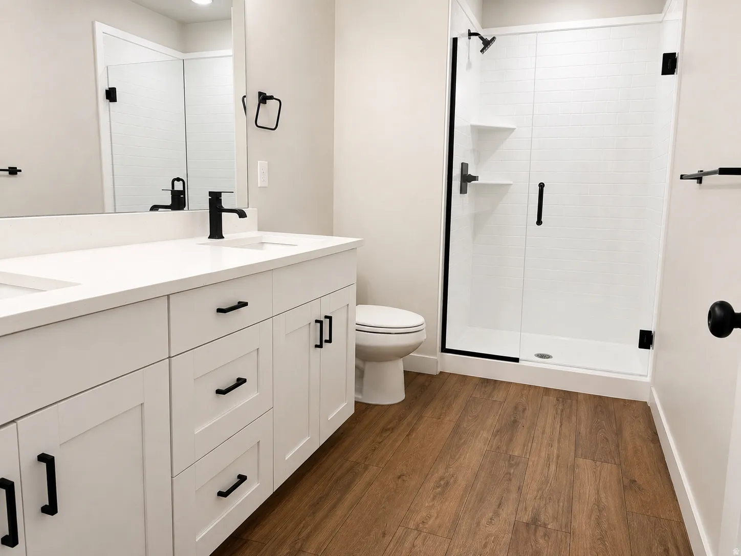 Bathroom featuring a double vanity with white cabinetry, white countertop, and matte black fixtures