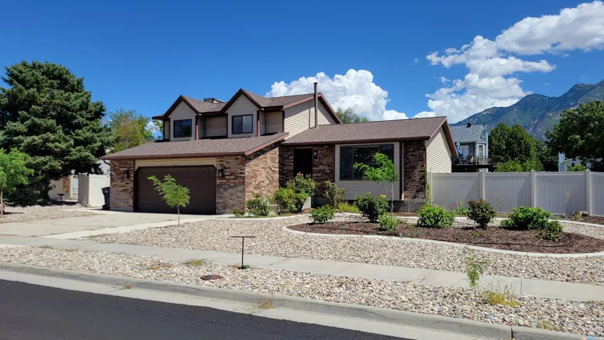 Stone veneer and siding exterior with a two-car garage
