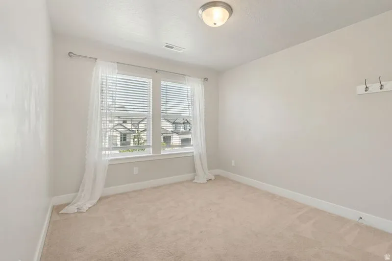 Neutral wall paint and plush carpeting create a versatile interior space