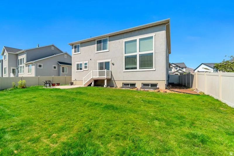 Expansive green lawn with a privacy fence