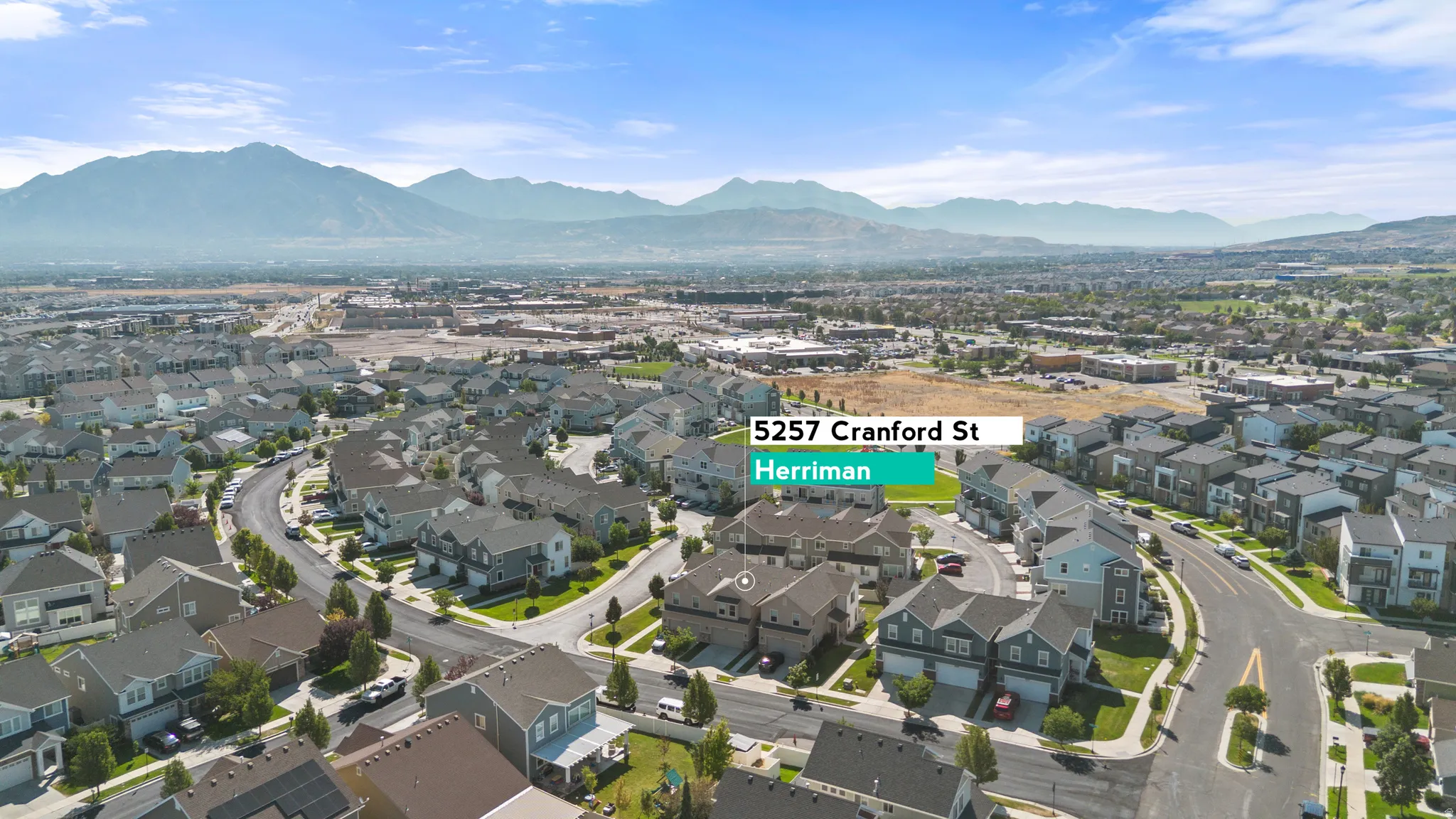 Aerial perspective of a residential neighborhood with mountain backdrop