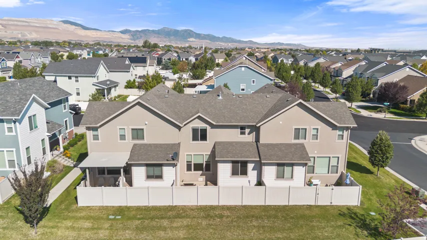 Multi-level townhome featuring a stucco exterior and gabled roofline