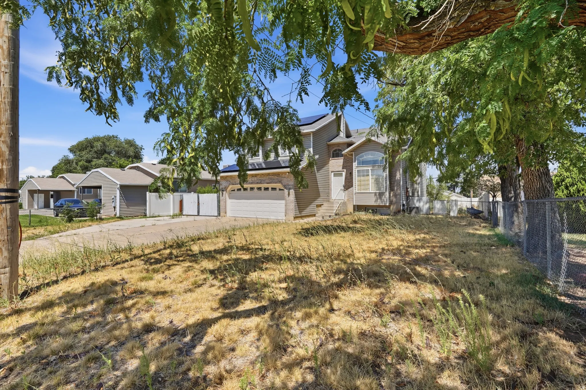Charming two-story residence with mature shade trees framing the property