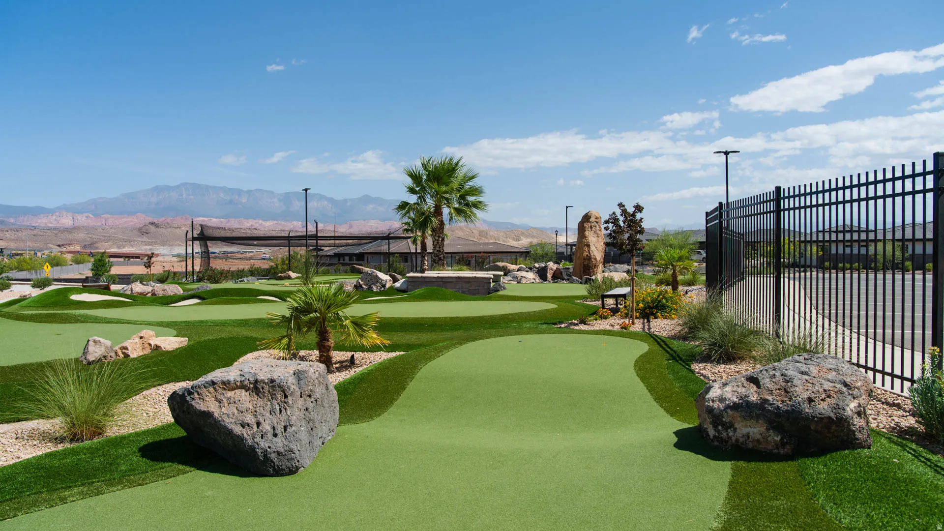 Miniature golf course featuring artificial turf greens and various rock formations