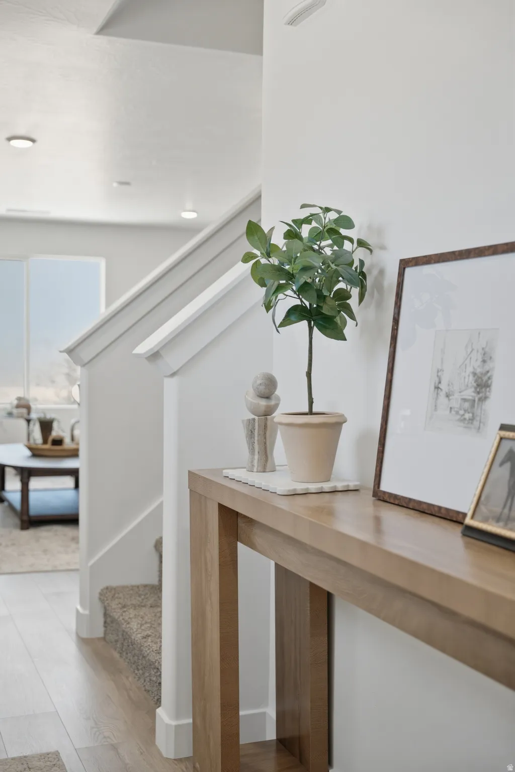 Bright, open entryway showcasing clean-lined architecture with vaulted ceilings and skylights flooding the space with natural light