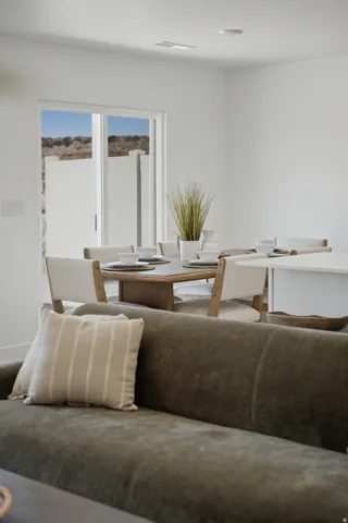 Modern home office and living space featuring expansive glass doors flooding the room with natural light, offering panoramic desert vistas