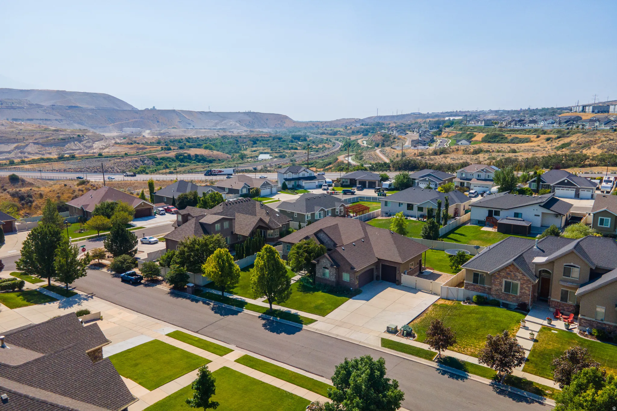 Residential neighborhood with varied architectural styles, mature trees, and landscaped properties