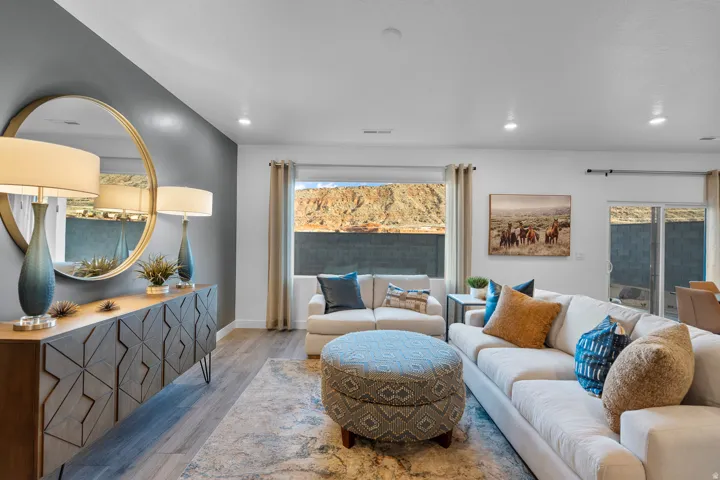 Open-concept living space featuring wood-finish flooring, recessed lighting, and a large picture window