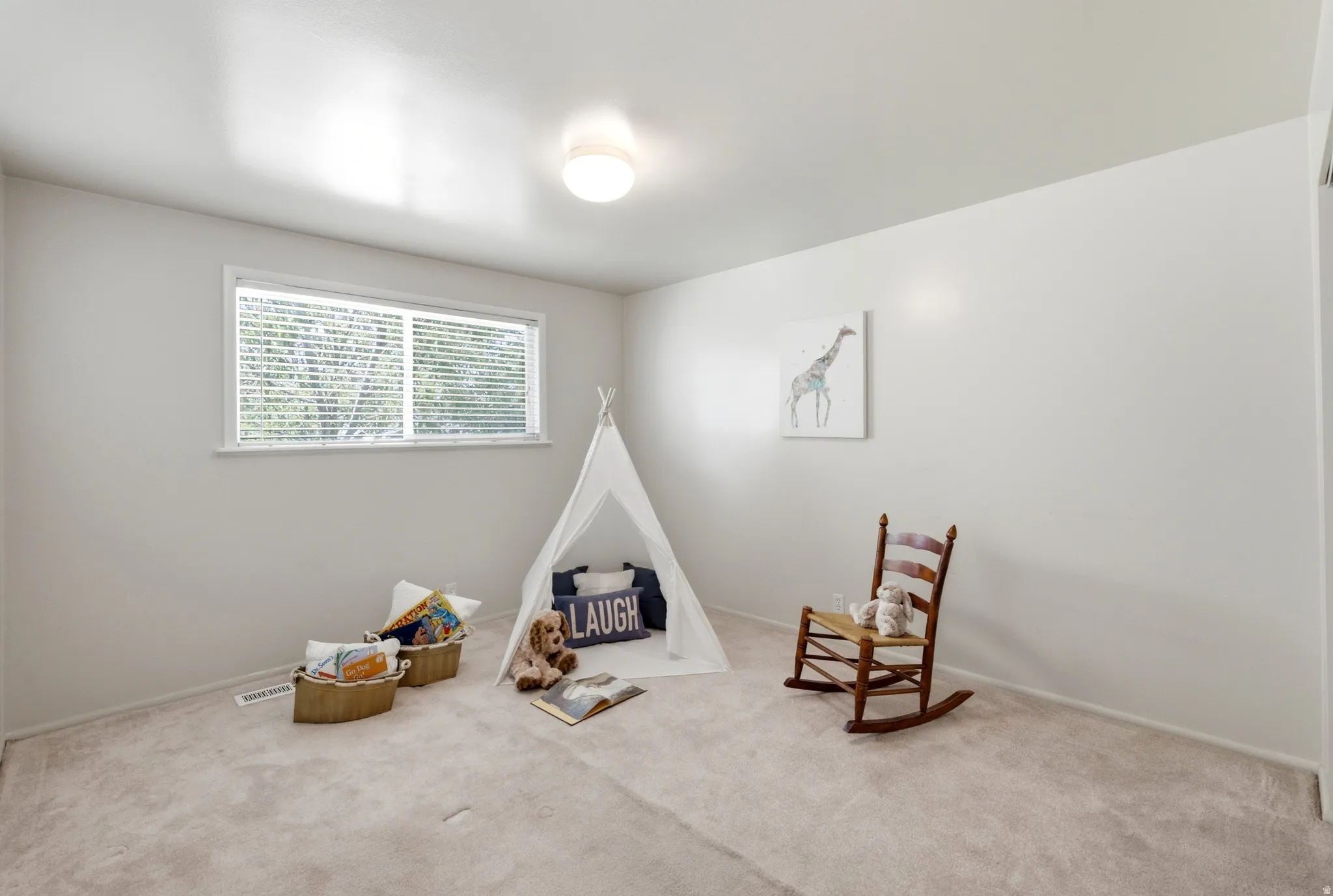 Light-colored wall-to-wall carpeting in a room featuring a rectangular window with blinds