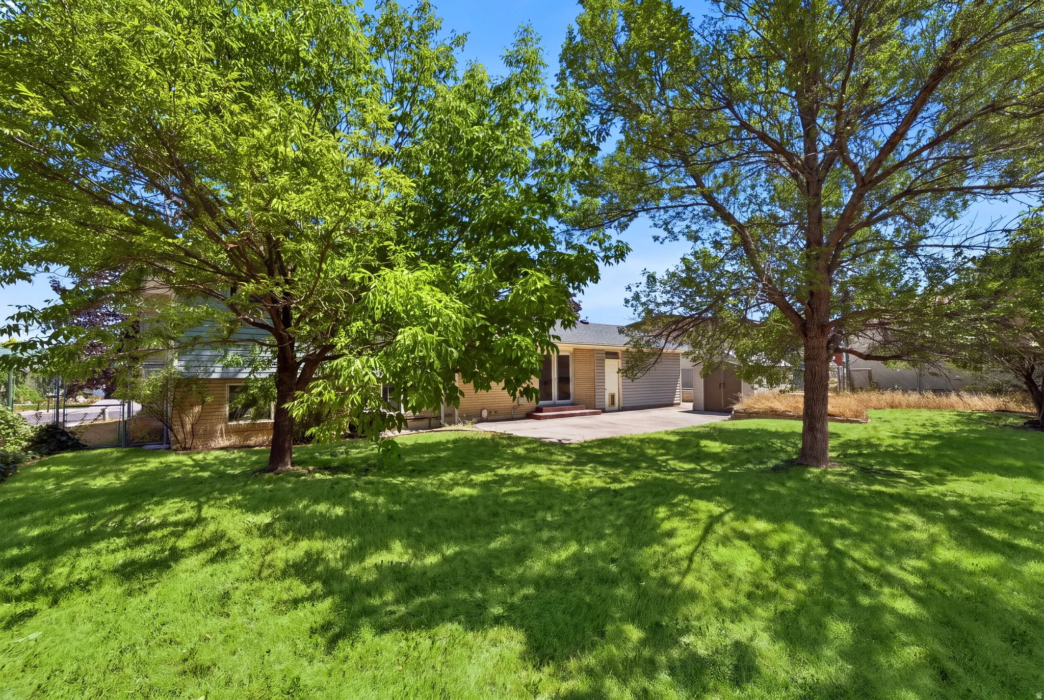Grass has been virtually enhanced in this image to illustrate the property's outdoor potential.