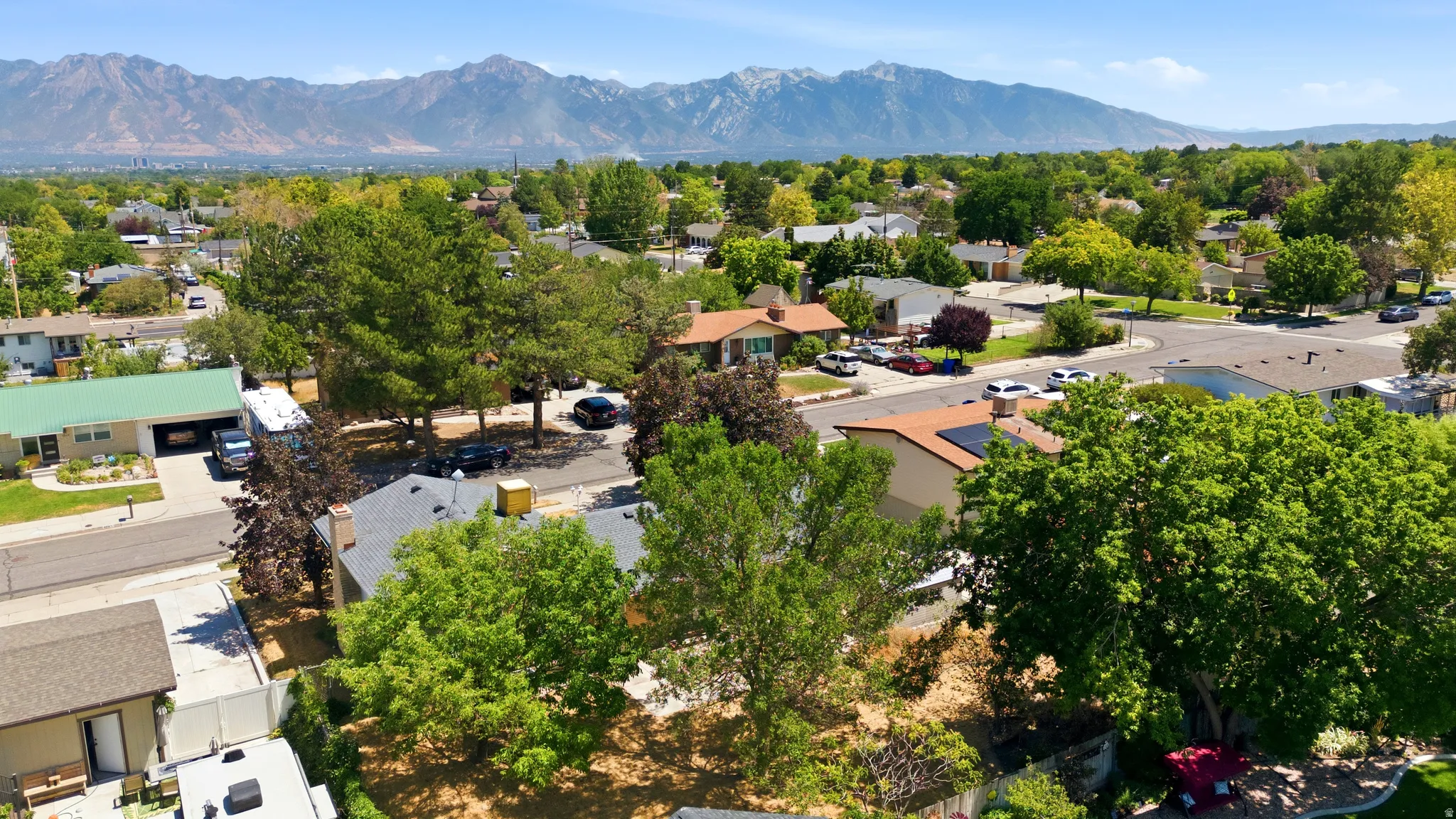 Expansive neighborhood panorama framed by majestic mountains