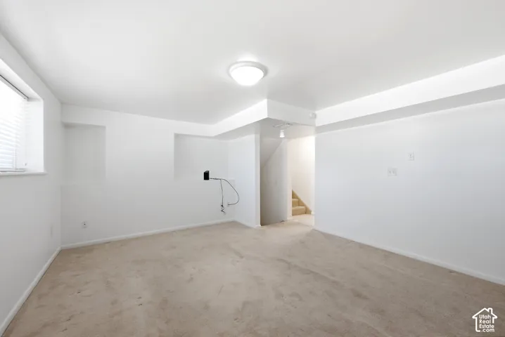 view family room into the hall and staircase,  recessed wall niches, and a ceiling-mounted light fixture