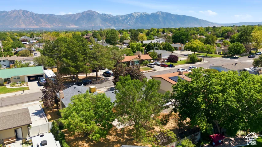 Expansive neighborhood panorama framed by majestic mountains