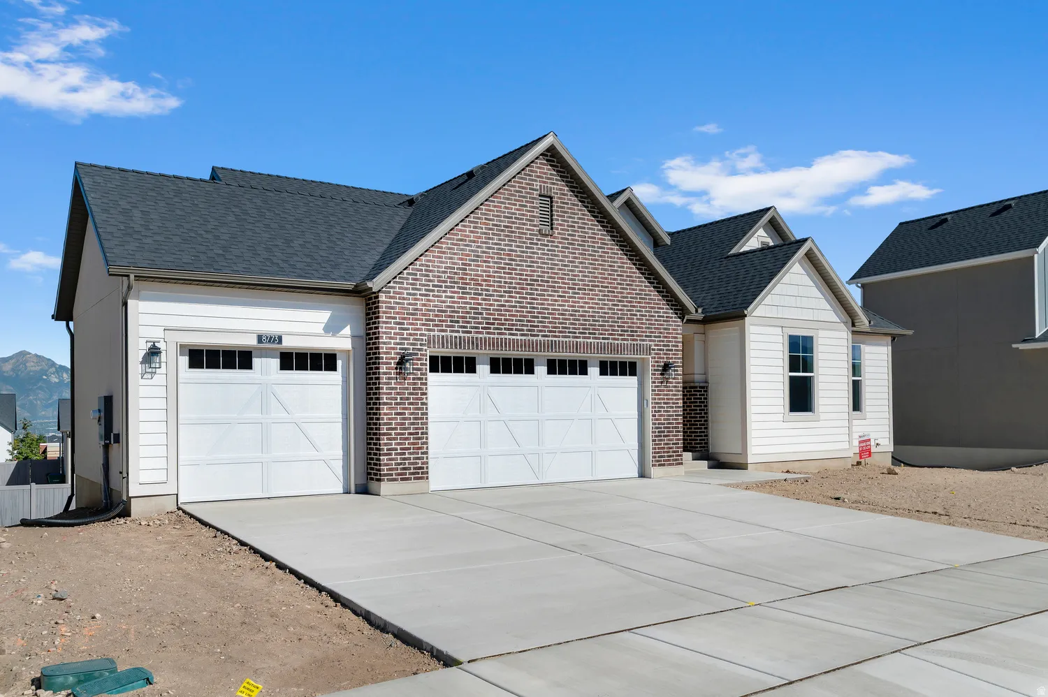 Brick and siding exterior with shingle roofing