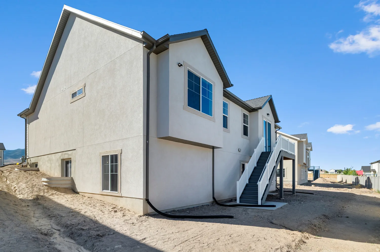 Stucco exterior with a multi-level deck and stairs