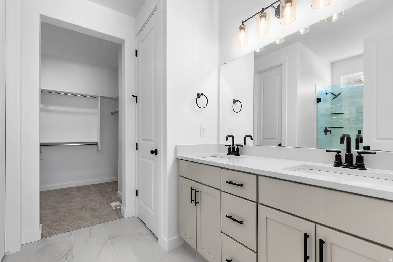 Double vanity with integrated sinks and black fixtures