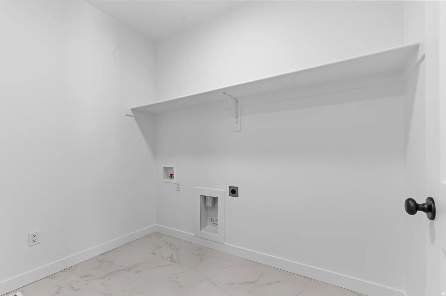 White interior walls, large built-in shelf, and tile flooring