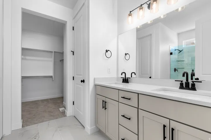 Double vanity with integrated sinks and black fixtures