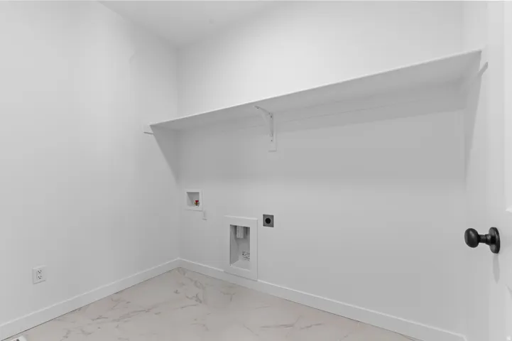 White interior walls, large built-in shelf, and tile flooring