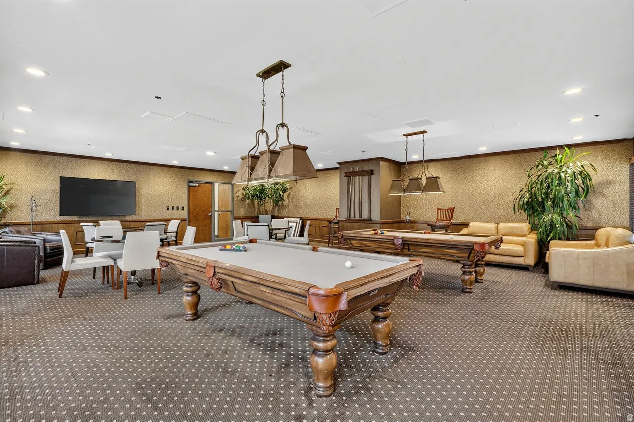 Recreation room featuring two billiards tables, recessed lighting, and a large wall-mounted display