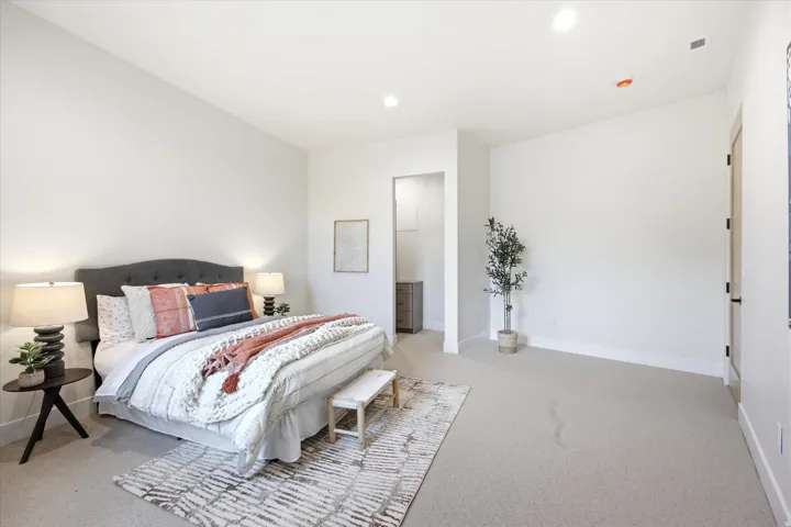 Spacious room featuring light-toned carpeting and recessed ceiling lighting