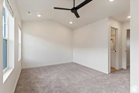 Vaulted ceiling with a black ceiling fan and recessed lighting