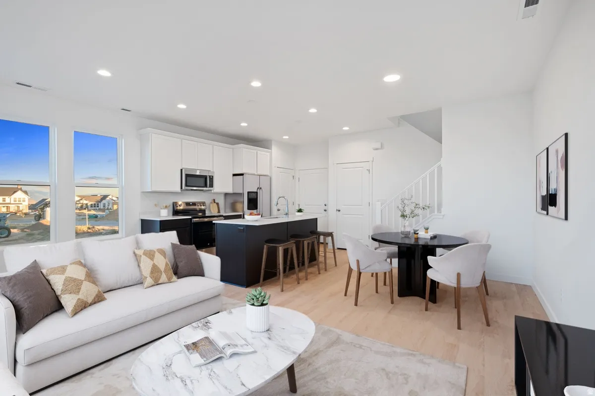 Open-concept living area with light wood-finish flooring
