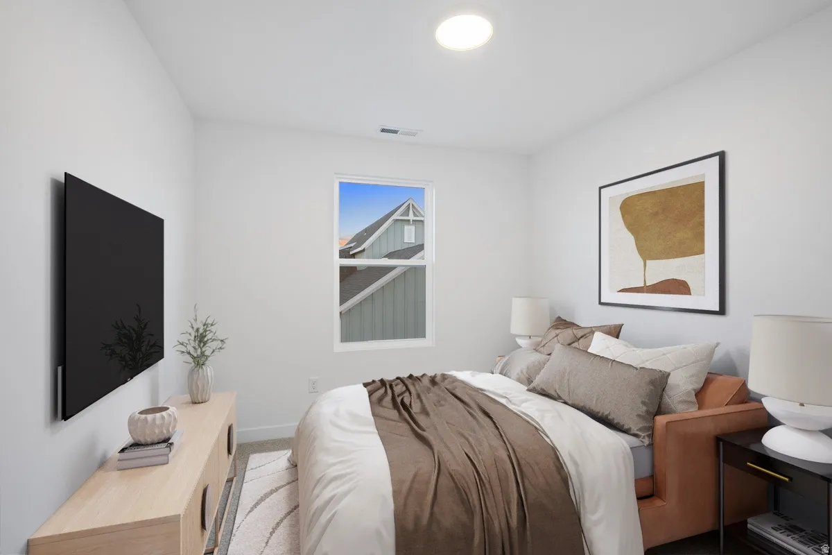 Bright bedroom featuring a single window, recessed lighting, and light-colored carpeting