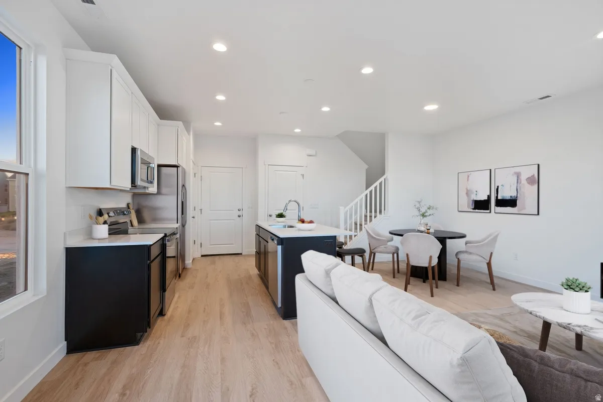 Open-concept living space featuring wood-finish flooring throughout