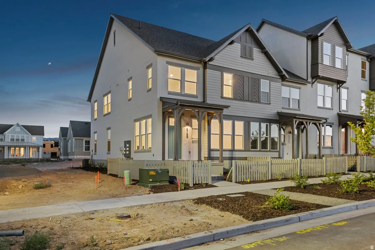 Contemporary townhome with a multi-textured facade featuring horizontal siding and stucco finishes