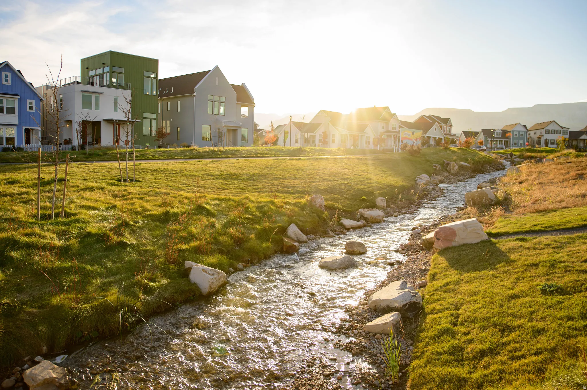 Water feature with natural rock elements, surrounded by grassy banks