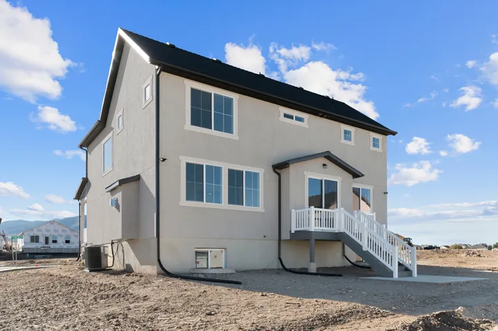 Contemporary stucco exterior with a black shingle roof