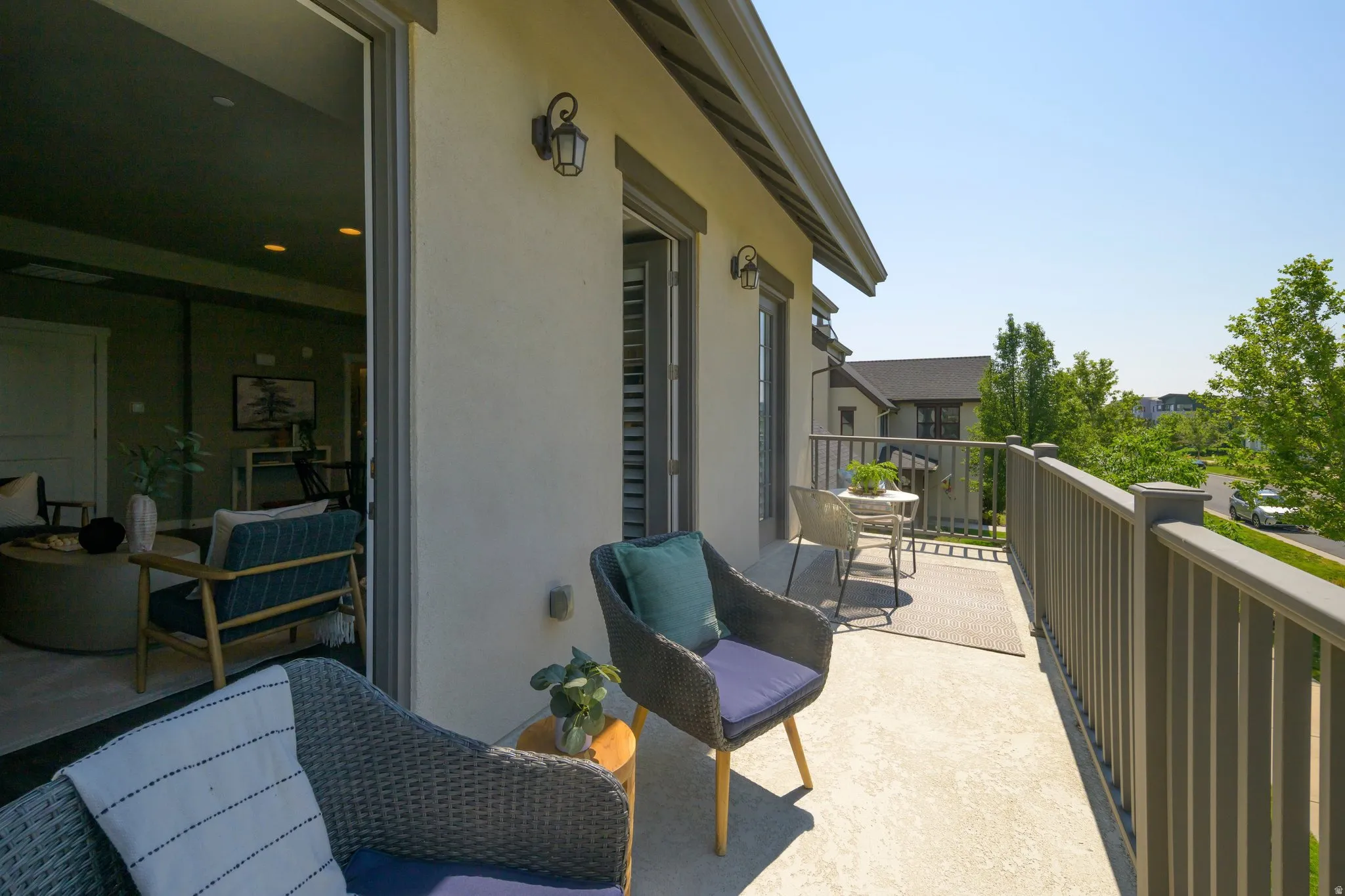 Outdoor balcony featuring a concrete surface and dark gray railing