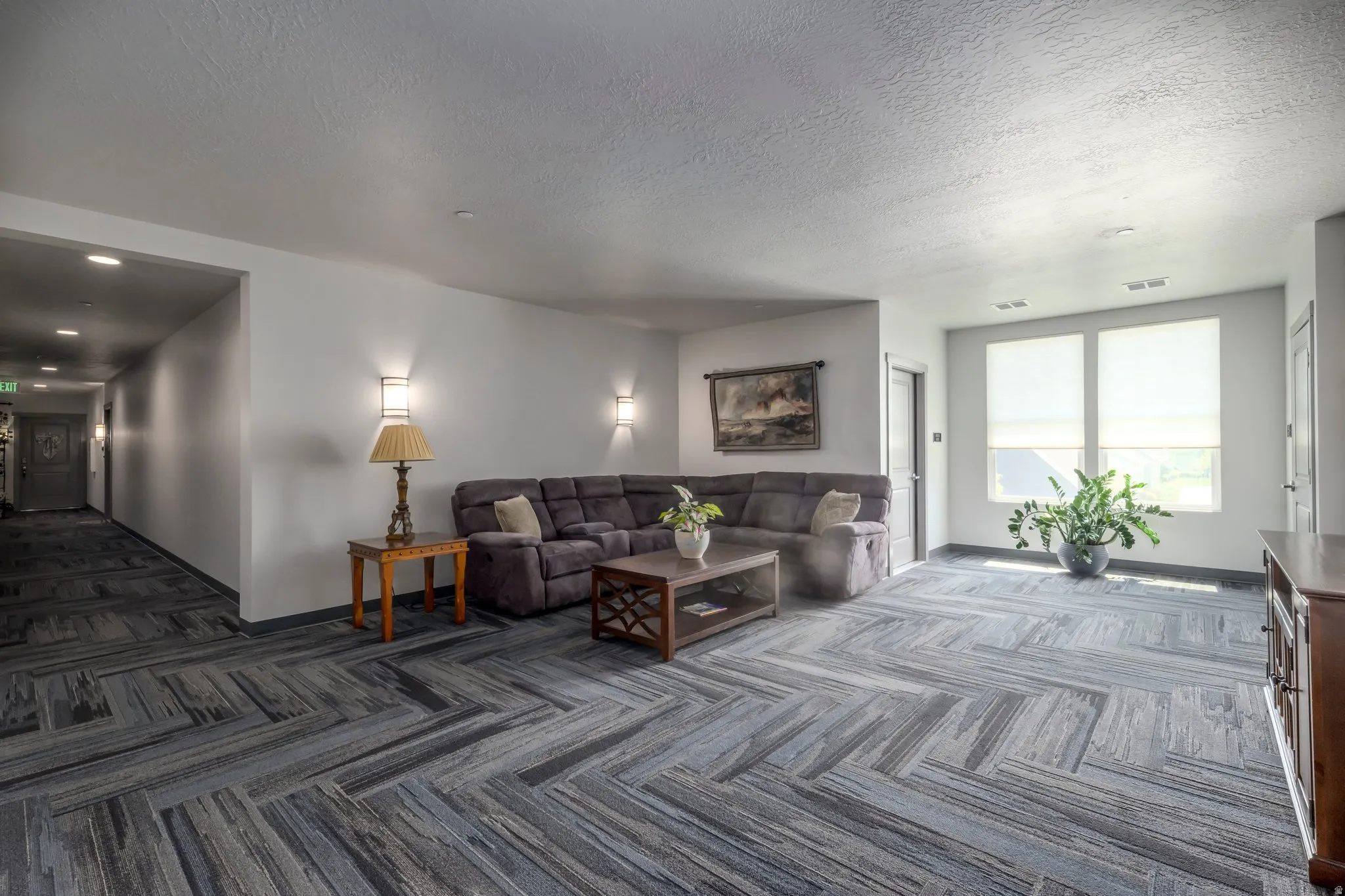 Open space featuring herringbone-patterned carpet