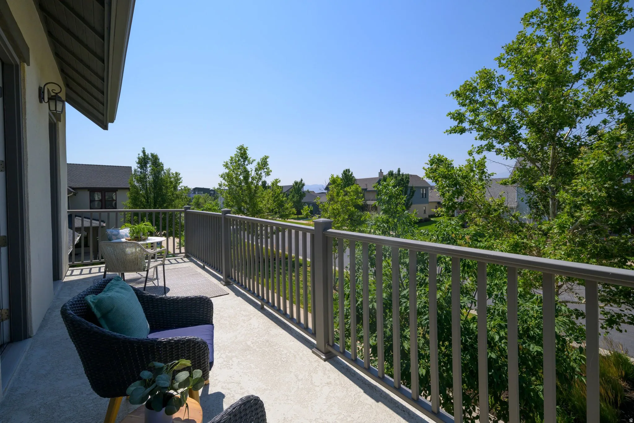 Outdoor balcony featuring a textured concrete surface and sturdy railing
