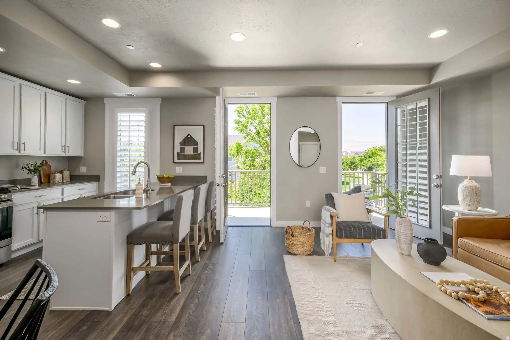 Open-concept living area featuring wood-finish flooring and recessed lighting