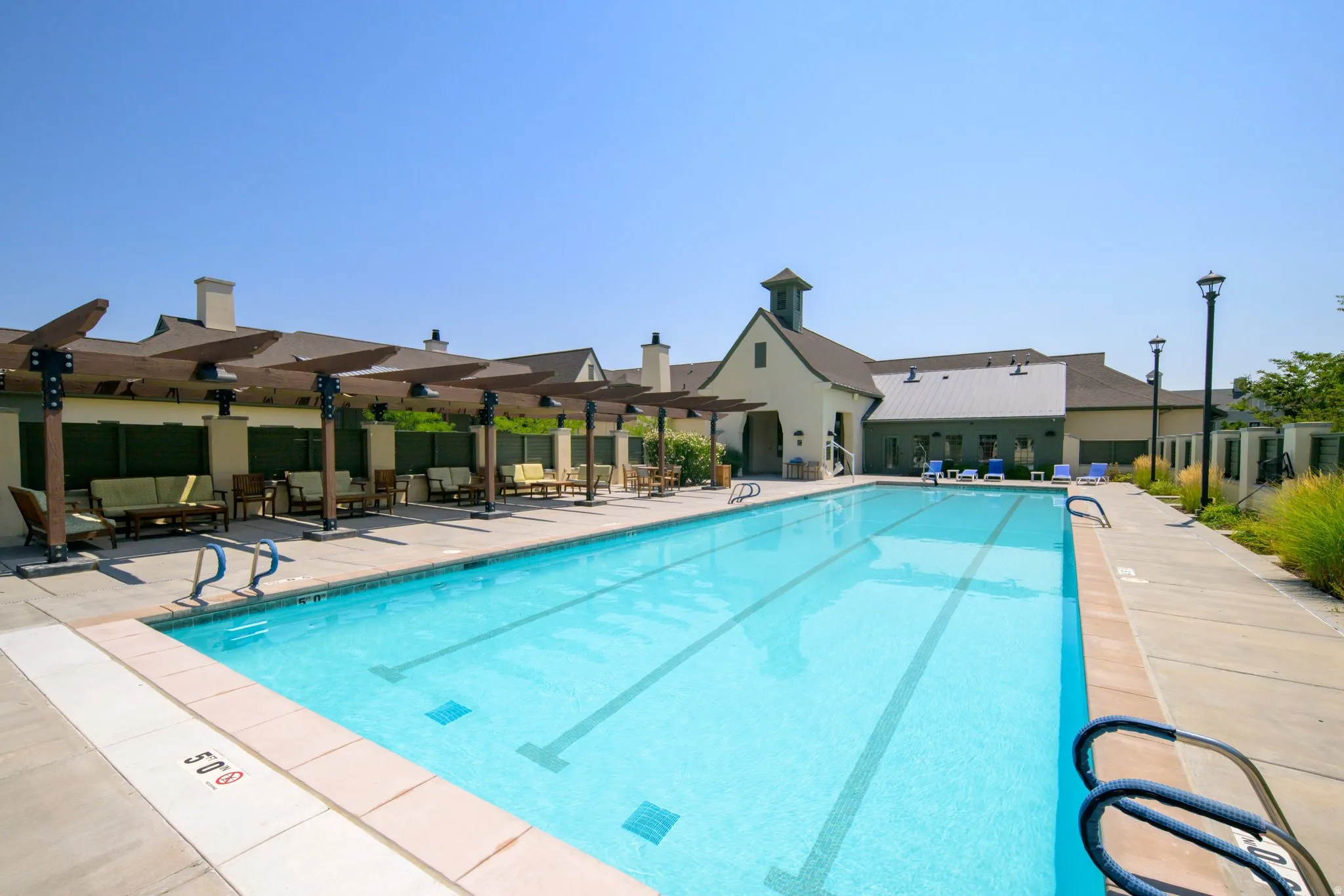Expansive outdoor swimming pool with integrated lap lanes and a surrounding concrete deck