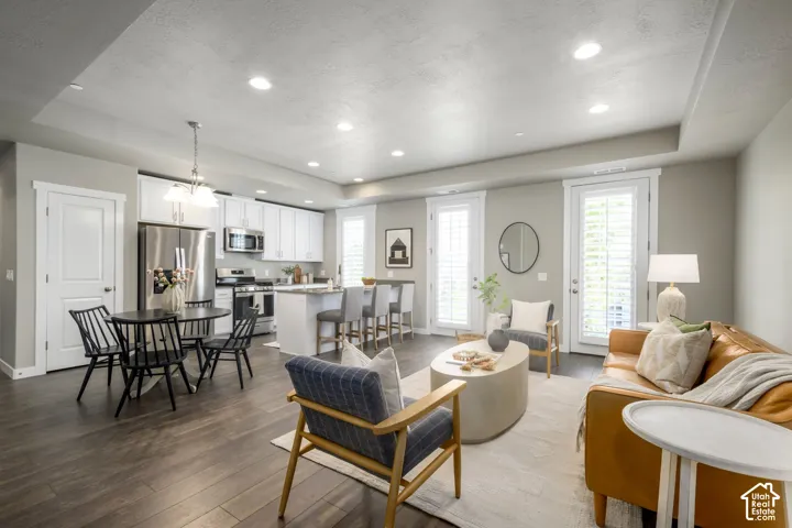 Open-concept living space featuring wood-finish flooring, recessed lighting, and a neutral color palette