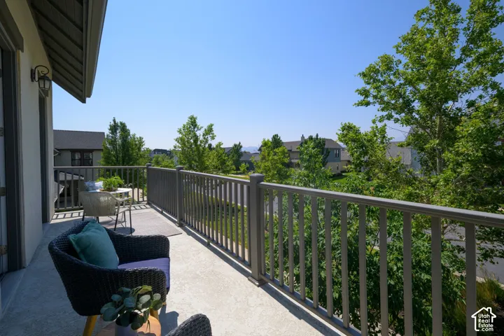 Outdoor balcony featuring a textured concrete surface and sturdy railing