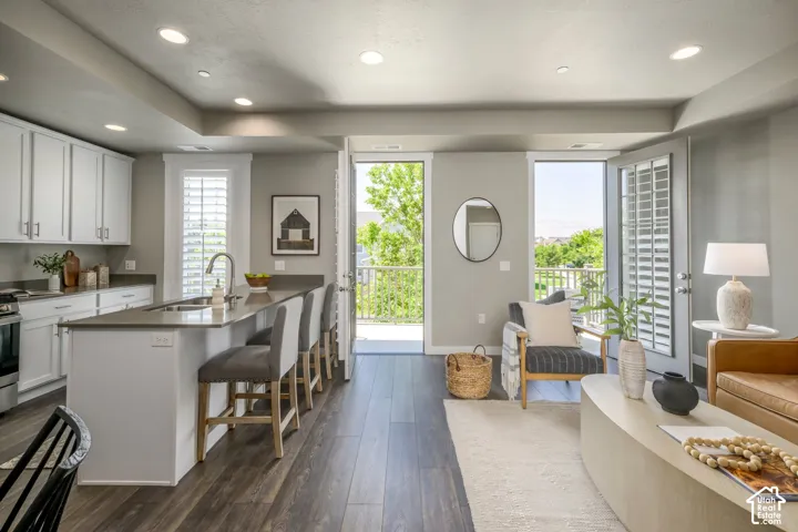 Open-concept living area featuring wood-finish flooring and recessed lighting