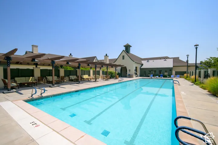 Expansive outdoor swimming pool with integrated lap lanes and a surrounding concrete deck